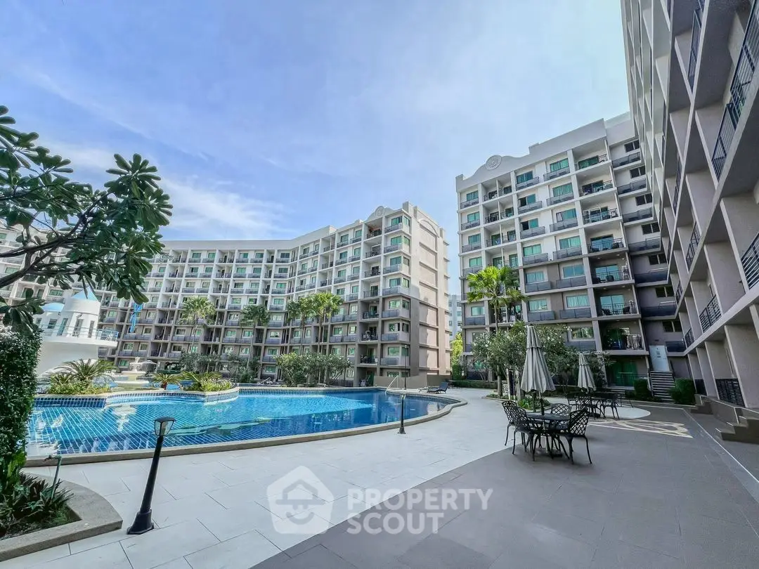 Luxurious condominium with pool and lush garden in modern residential complex.