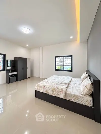 Spacious modern bedroom with sleek furniture and natural light