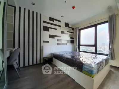Modern bedroom with large window and stylish wall design in urban apartment