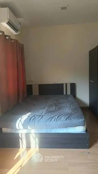 Cozy bedroom with modern bed and natural light, perfect for relaxation.