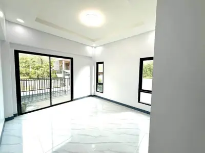 Bright and spacious living room with large windows and balcony access