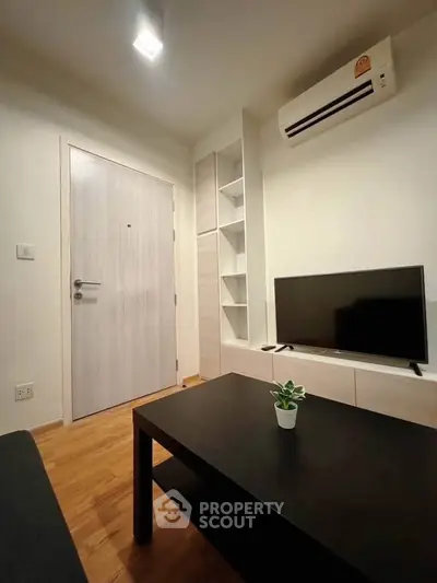 Modern living room with sleek furniture and air conditioning, perfect for cozy living.