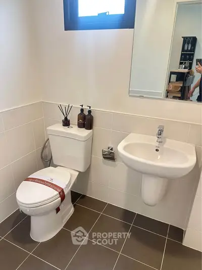 Modern bathroom with sleek fixtures and neutral tiles, perfect for a contemporary home.