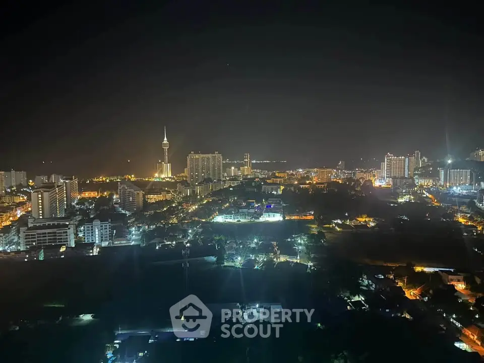 Stunning night cityscape view showcasing illuminated skyline and iconic tower.