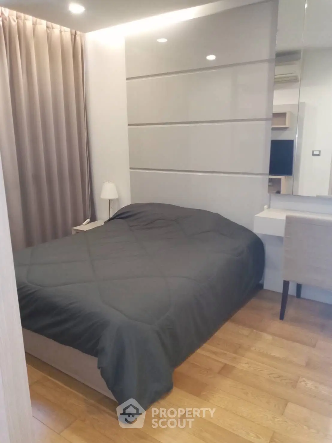 Modern bedroom with sleek design and cozy ambiance, featuring hardwood floors and stylish furnishings.