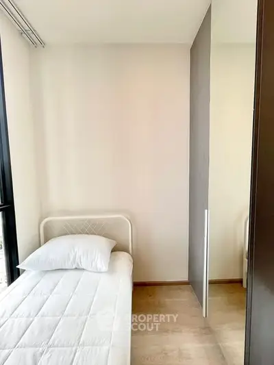 Cozy minimalist bedroom with single bed and natural light