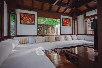 Luxurious living room with elegant wooden decor and large comfortable seating, perfect for relaxation.
