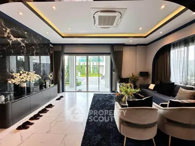 Luxurious modern living room with elegant decor, marble accents, and large sliding glass doors opening to a garden view.