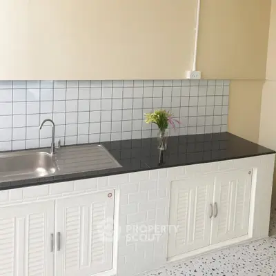 Modern kitchen with sleek countertop and stylish backsplash