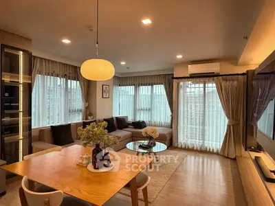 Spacious modern living room with large windows and elegant decor