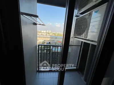 Compact balcony with city view and air conditioning unit, ideal for urban living.