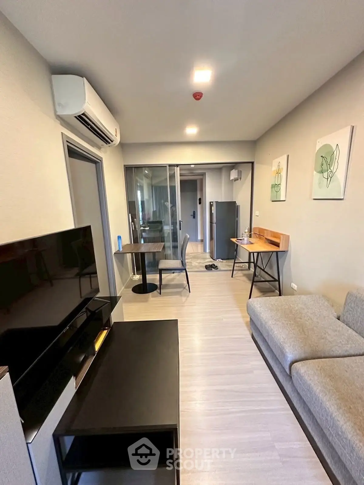 Modern living room with sleek furniture and air conditioning in a stylish apartment.