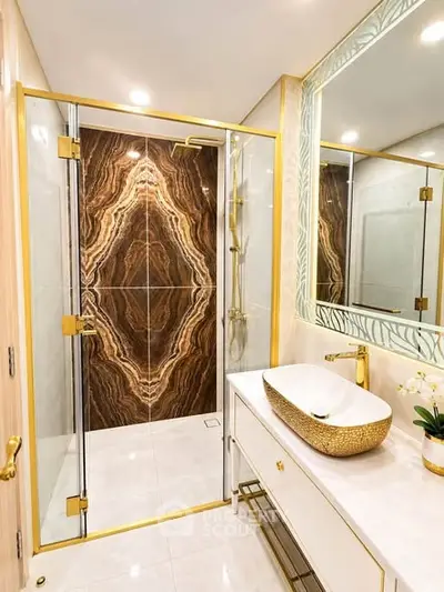 Luxurious bathroom with gold accents and elegant marble shower design.