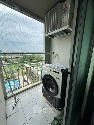 Compact balcony with washing machine and scenic view of pool and cityscape.