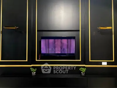 Luxurious black and gold living room with built-in TV and elegant decor