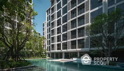 Modern condominium with pool and lush greenery in urban setting