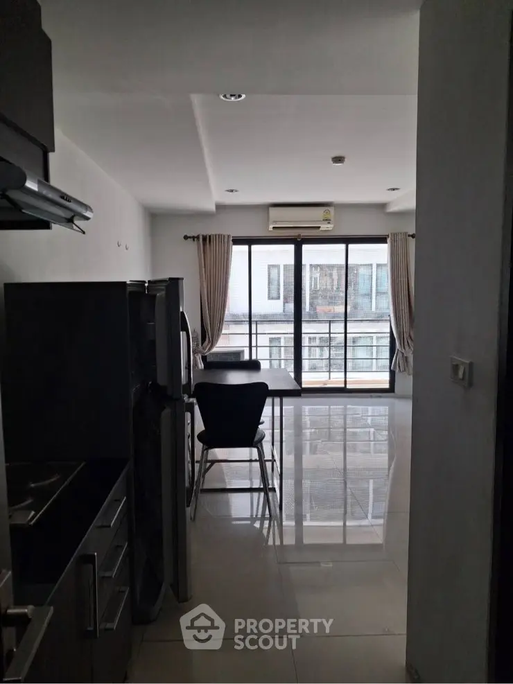 Modern apartment with open layout and large windows offering city views.