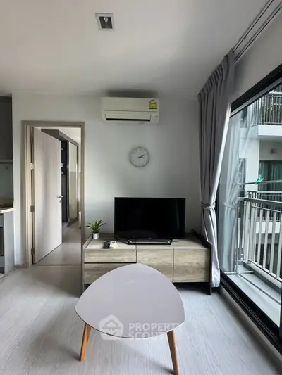 Modern living room with sleek furniture and balcony view in a stylish apartment.