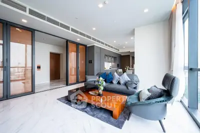 Luxurious modern living room with elegant furniture and open kitchen layout in high-rise apartment.