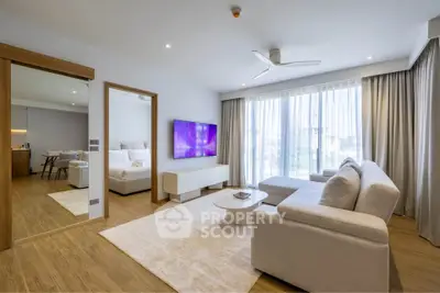 Modern living room with elegant decor and large windows in a stylish apartment.