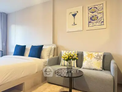 Chic modern bedroom with cozy sofa and stylish decor, perfect for urban living.
