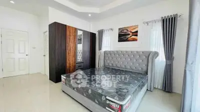 Spacious bedroom with modern decor and large bed in a bright, airy setting.