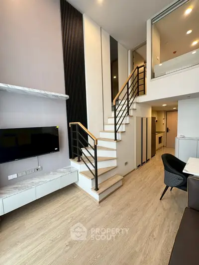 Modern duplex living room with stylish staircase and sleek interior design