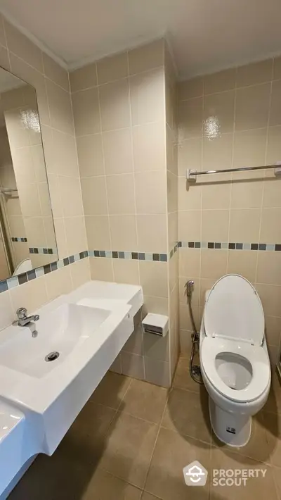 Modern bathroom with sleek fixtures and neutral tiles