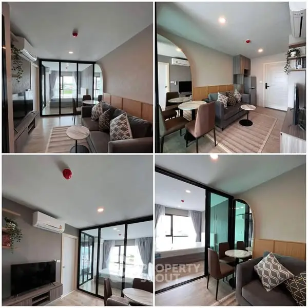 Modern living room with stylish decor and glass partition, featuring cozy seating and elegant lighting.