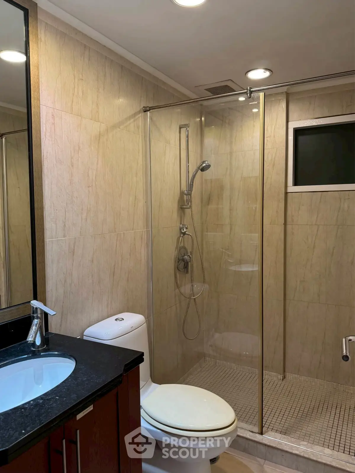 Modern bathroom with glass shower and sleek fixtures in a contemporary home.