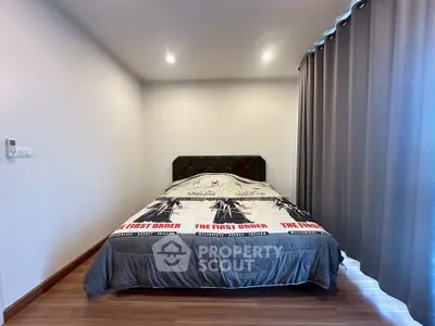 Cozy bedroom with modern decor and stylish bedding in a well-lit space.