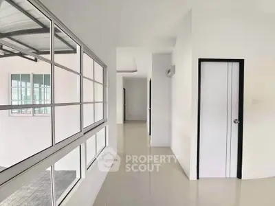 Bright and spacious corridor with large windows in modern building