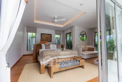 Luxurious modern bedroom with elegant decor and garden view, featuring cozy seating area.