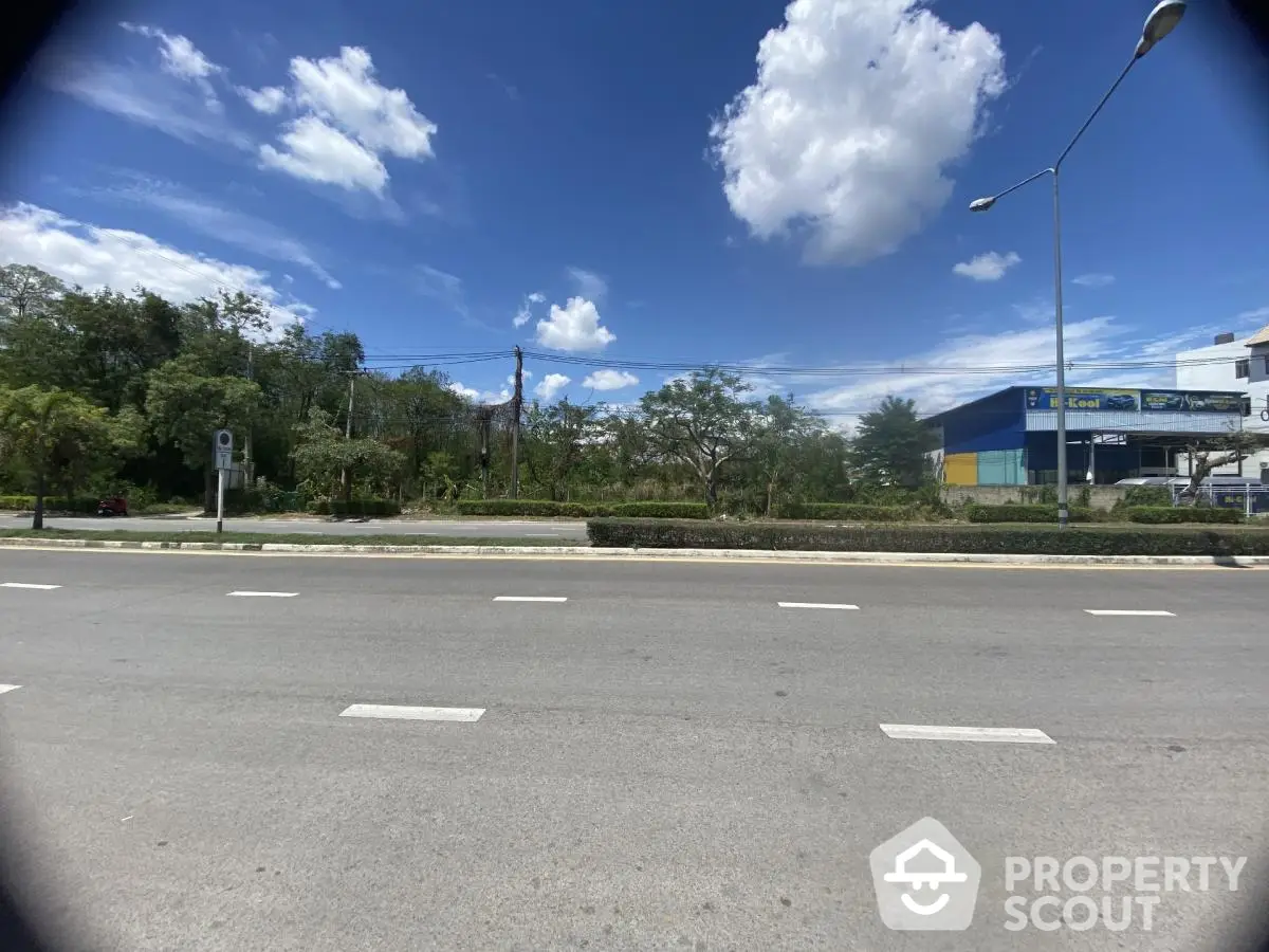 Expansive roadside view with clear blue sky, ideal for commercial real estate opportunities.