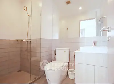 Modern bathroom with sleek design and spacious shower area in a contemporary home.