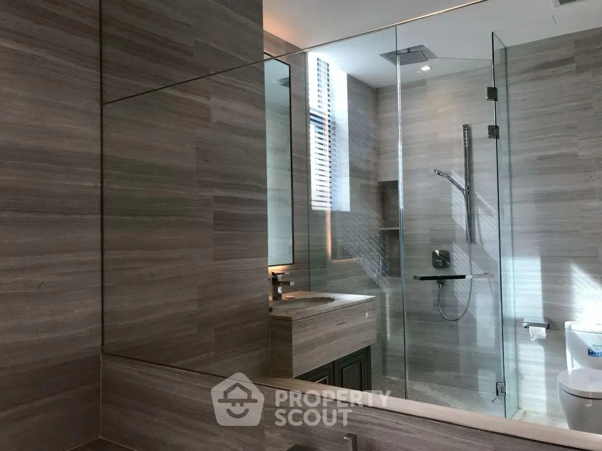 Luxurious modern bathroom with glass shower and elegant fixtures