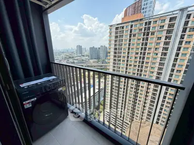 High-rise apartment balcony with cityscape view and washing machine.