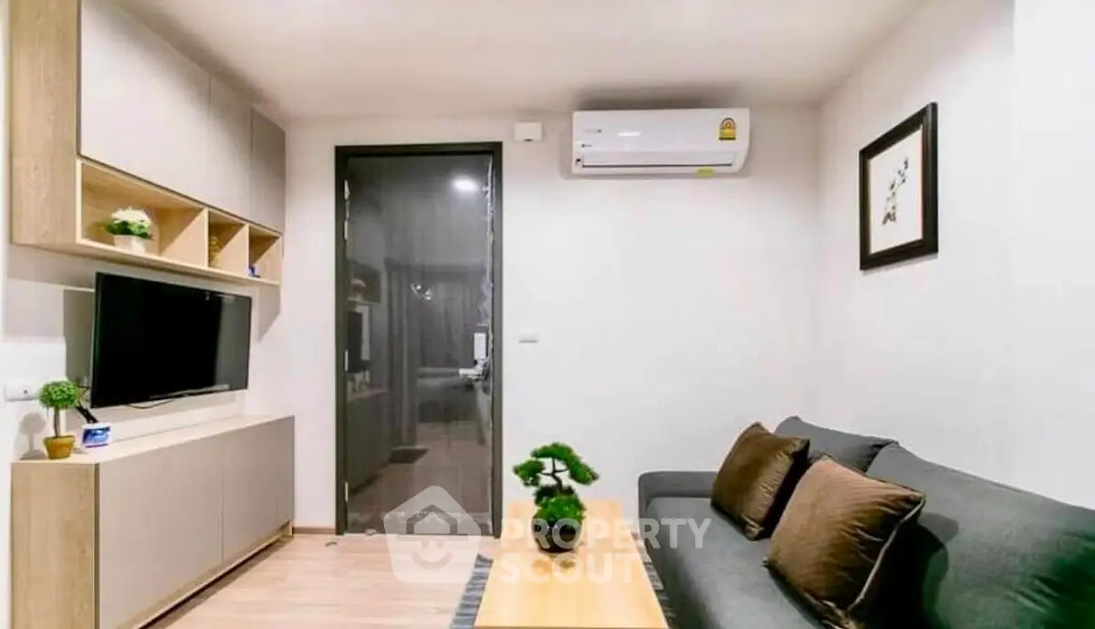 Modern living room with sleek furniture and air conditioning, perfect for cozy urban living.