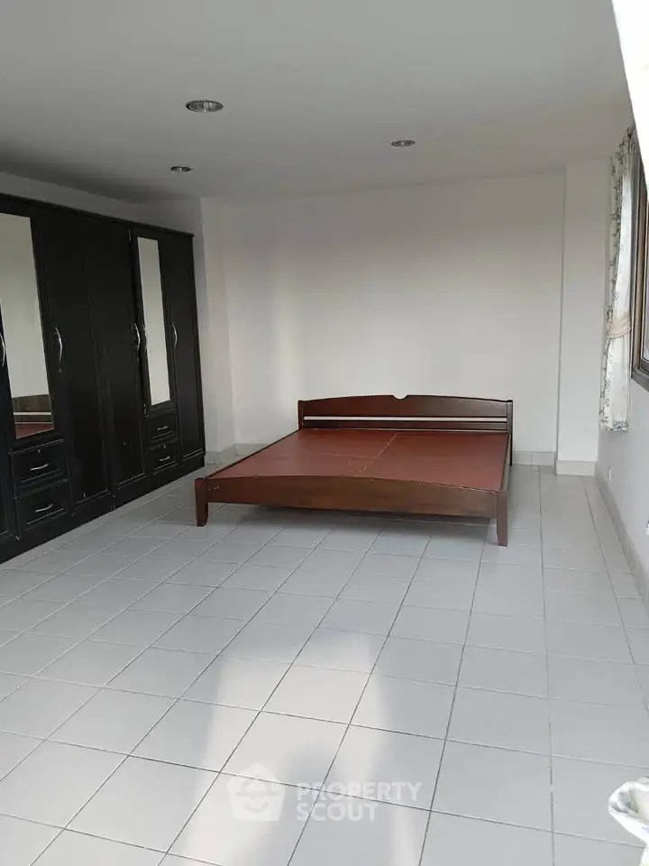 Spacious bedroom with large wardrobe and natural light