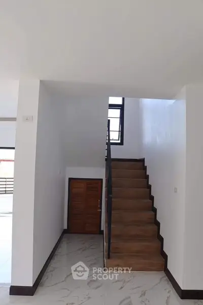 Modern interior staircase with wooden steps and sleek design