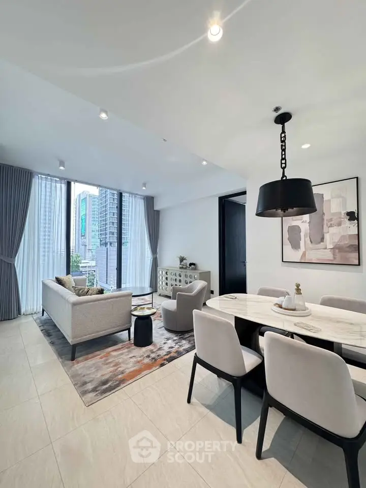 Modern living room with dining area, large windows, and city view.