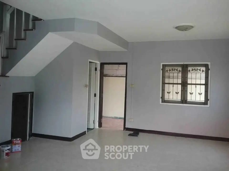 Spacious interior with staircase and window, ideal for modern living.