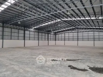 Spacious industrial warehouse with high ceilings and ample storage space.
