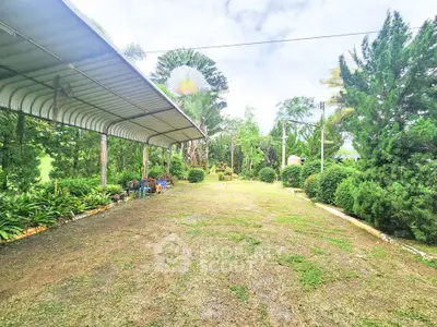 Spacious garden area with lush greenery and covered seating, perfect for outdoor relaxation.