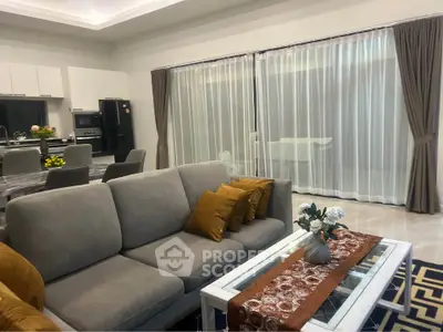 Spacious modern living room with elegant decor and open kitchen layout, perfect for entertaining.