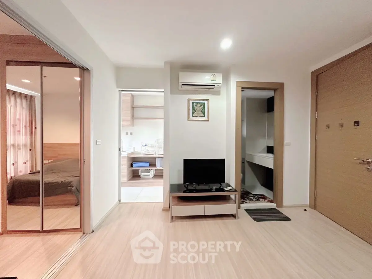 Modern apartment interior with open living space and bedroom view