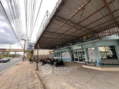 Commercial property with parking area and street view, ideal for business opportunities.