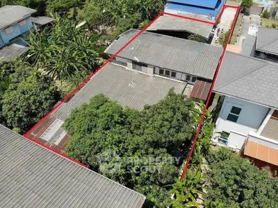 Aerial view of a residential property with lush greenery and spacious layout.
