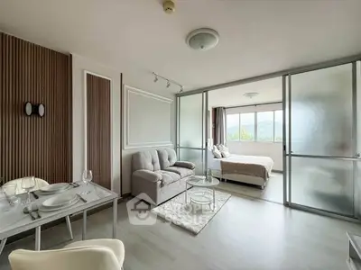 Modern open-plan living room with elegant decor and scenic view from bedroom