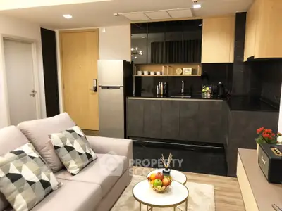 Modern open-layout kitchen and living room with sleek design and cozy decor.